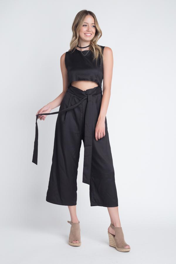 A stylish women's sleeveless tie jumpsuit featuring a chic slit, perfect for warm weather occasions.