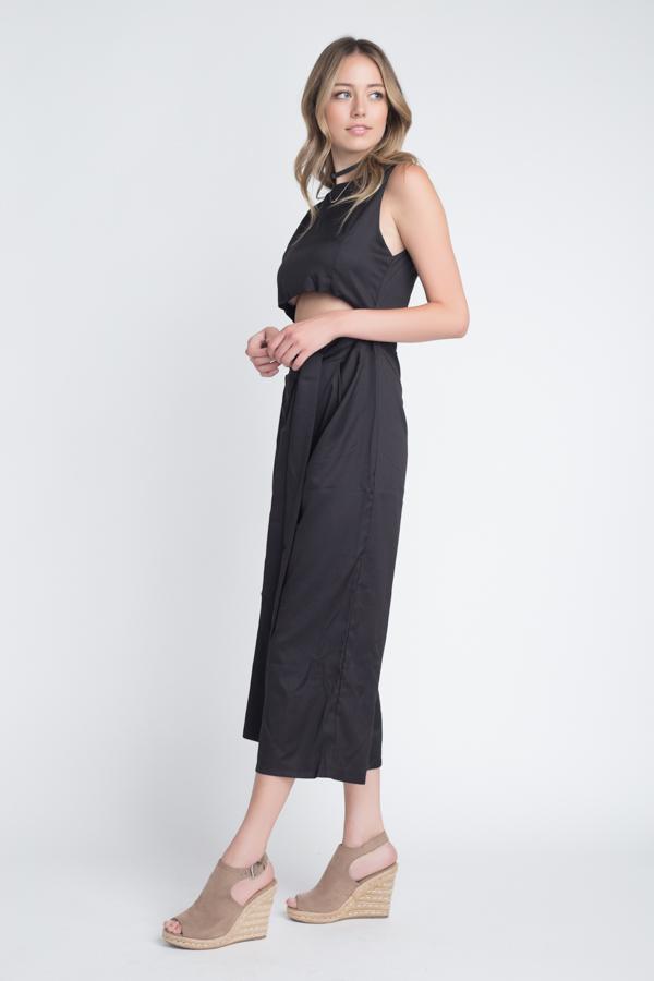 A stylish women's sleeveless tie jumpsuit featuring a chic slit, perfect for warm weather occasions.