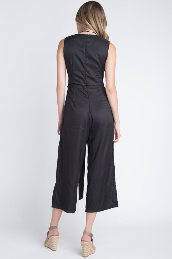 A stylish women's sleeveless tie jumpsuit featuring a chic slit, perfect for warm weather occasions.