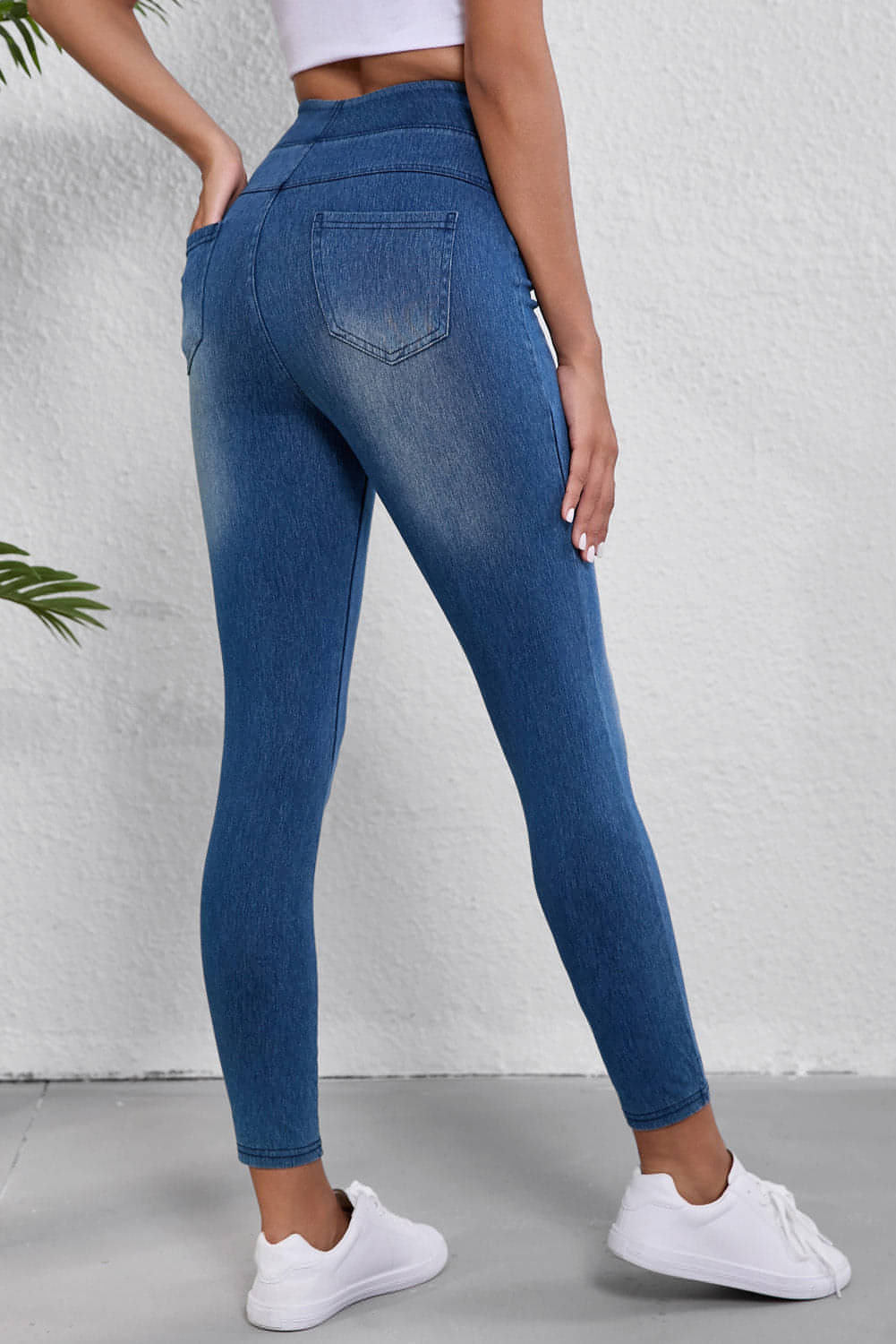 Navy blue skinny jeggings with elastic waistband, ankle length, and functional pockets, perfect for stylish comfort.