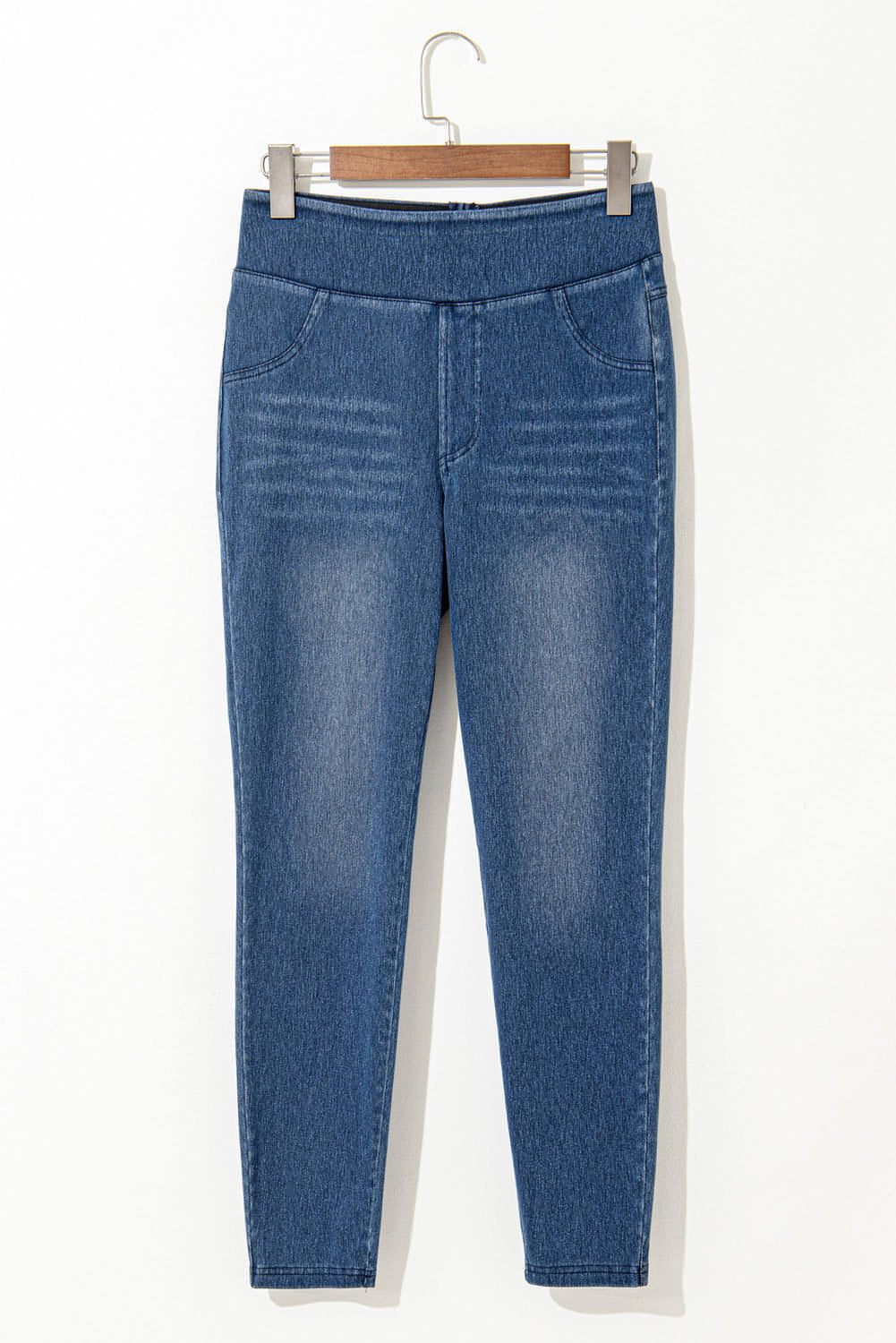 Navy blue skinny jeggings with elastic waistband, ankle length, and functional pockets, perfect for stylish comfort.