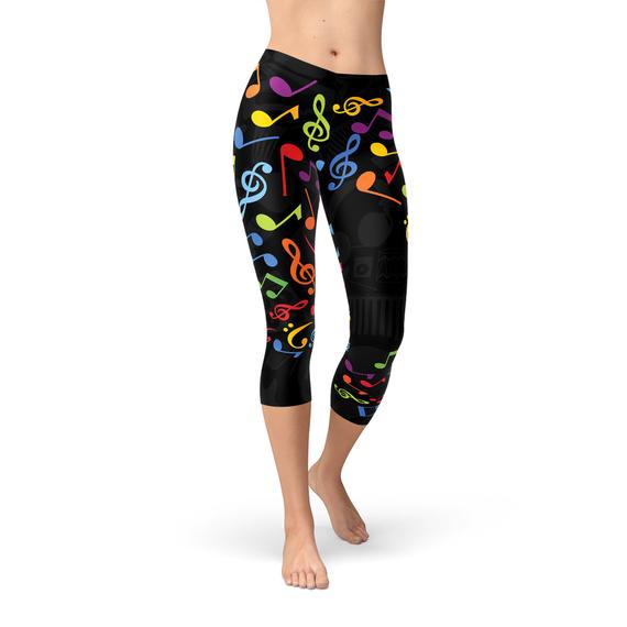 A pair of Women's Colorful Music Notes Capri Leggings featuring a vibrant music notes design, showcasing their four-way stretch and comfortable fit.