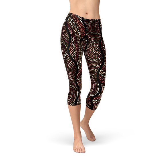 Women's capri leggings featuring vibrant polka dots and Aboriginal artwork, designed for comfort and performance.