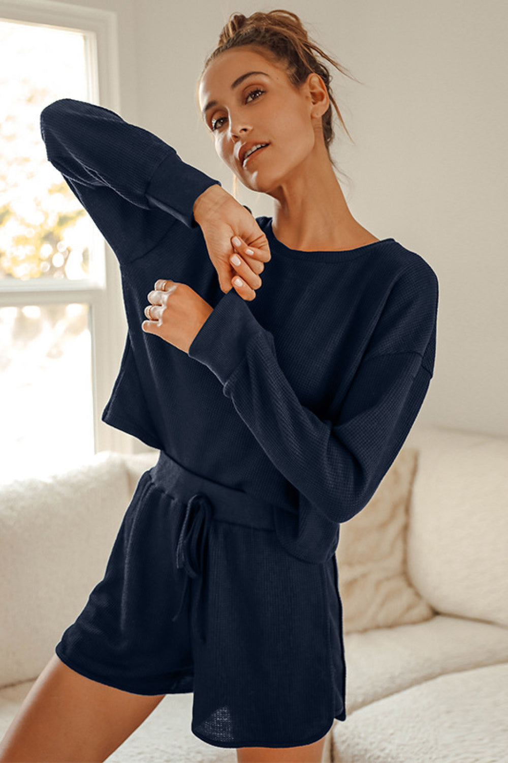 A stylish Crop Top and Shorts Lounge Set featuring a relaxed fit, long sleeves, and tie waist shorts, perfect for casual wear.