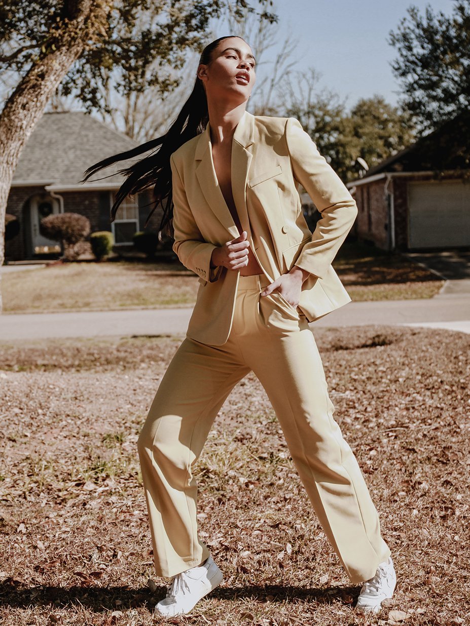 Stella Tailored Pants in vibrant yellow, featuring a high-rise silhouette and center pleat detailing, perfect for stylish women.