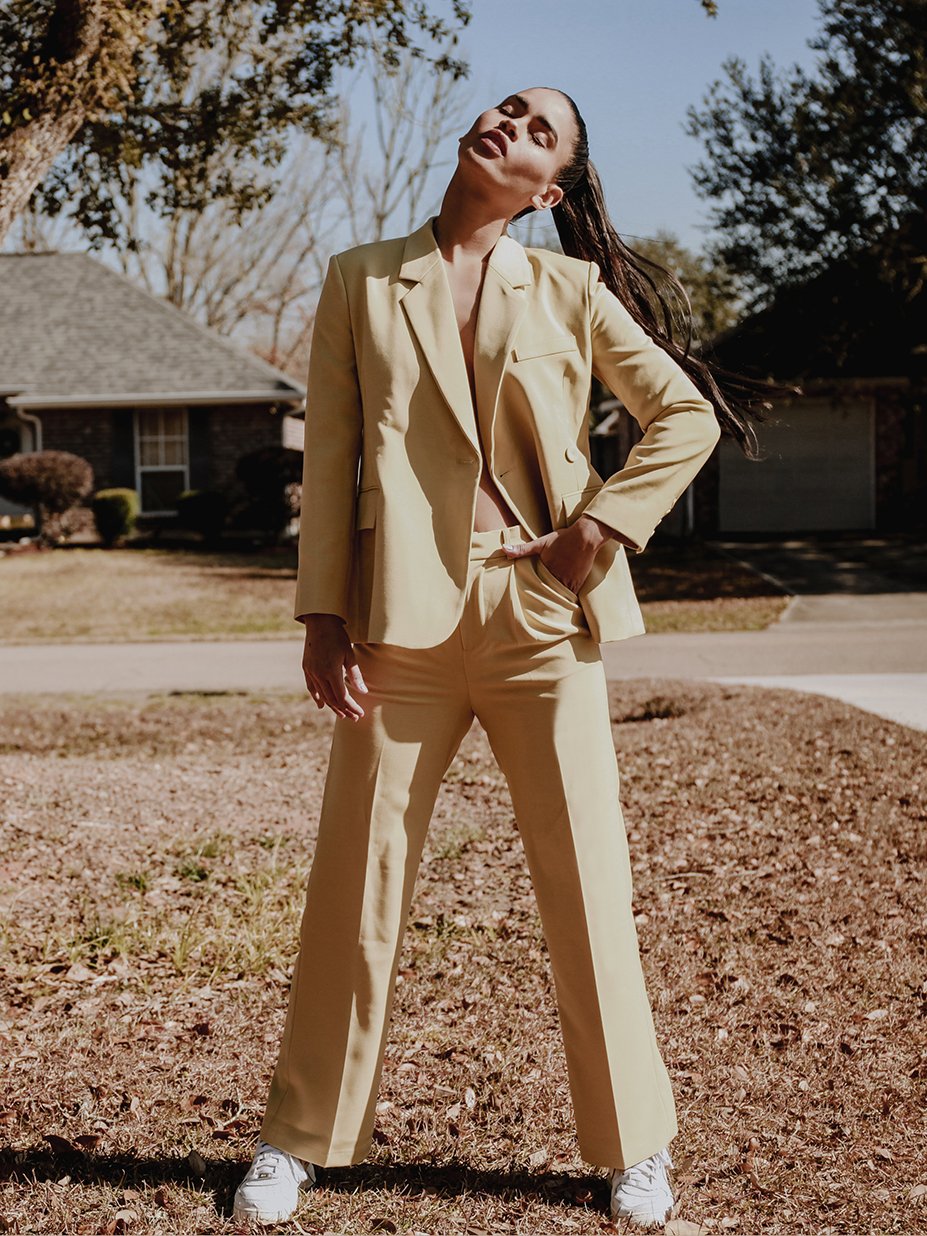 Stella Tailored Pants in vibrant yellow, featuring a high-rise silhouette and center pleat detailing, perfect for stylish women.