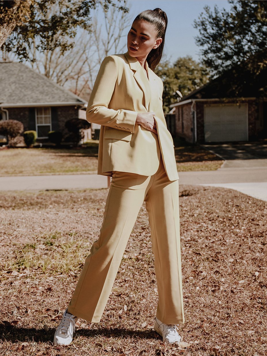 Stella Tailored Pants in vibrant yellow, featuring a high-rise silhouette and center pleat detailing, perfect for stylish women.