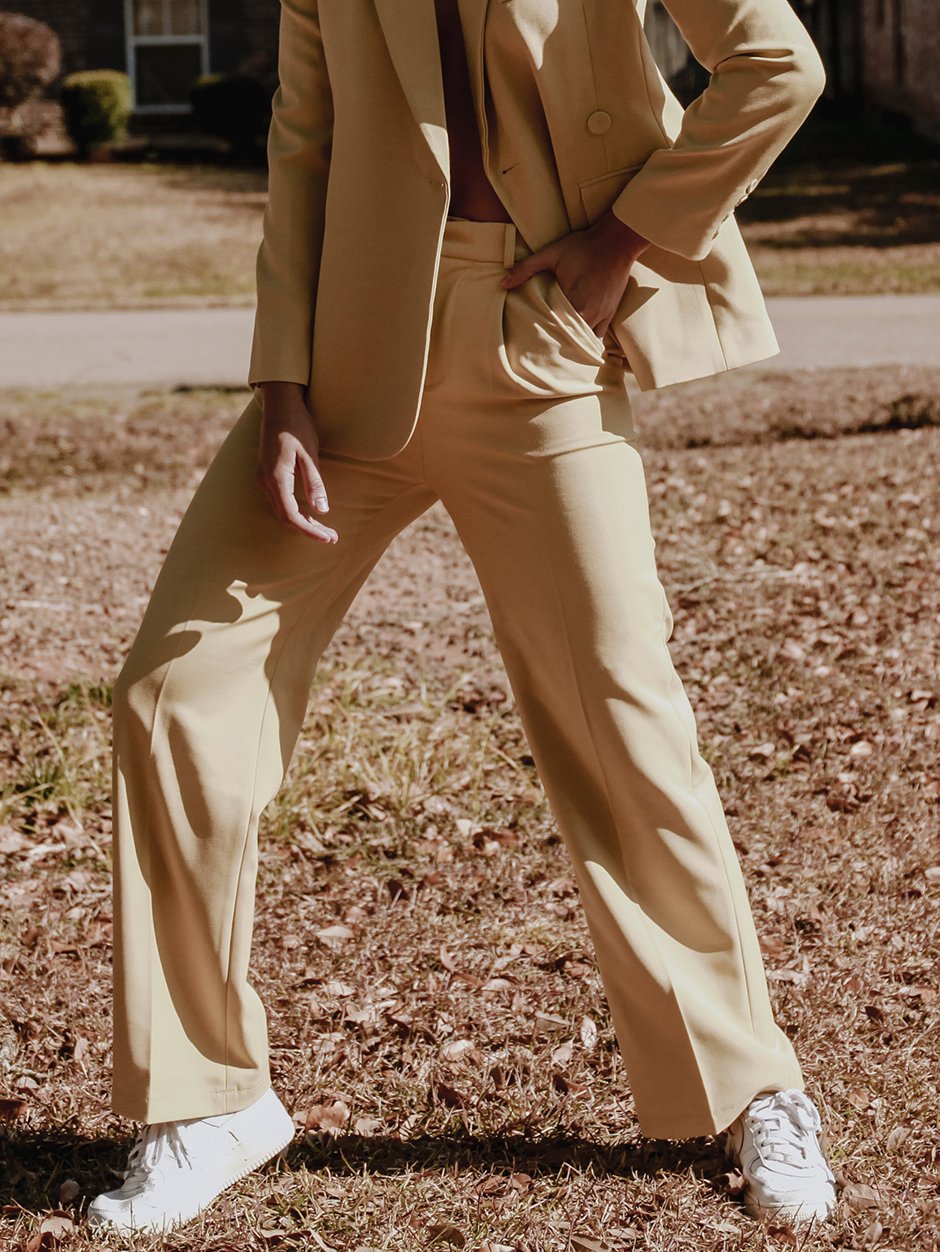 Stella Tailored Pants in vibrant yellow, featuring a high-rise silhouette and center pleat detailing, perfect for stylish women.