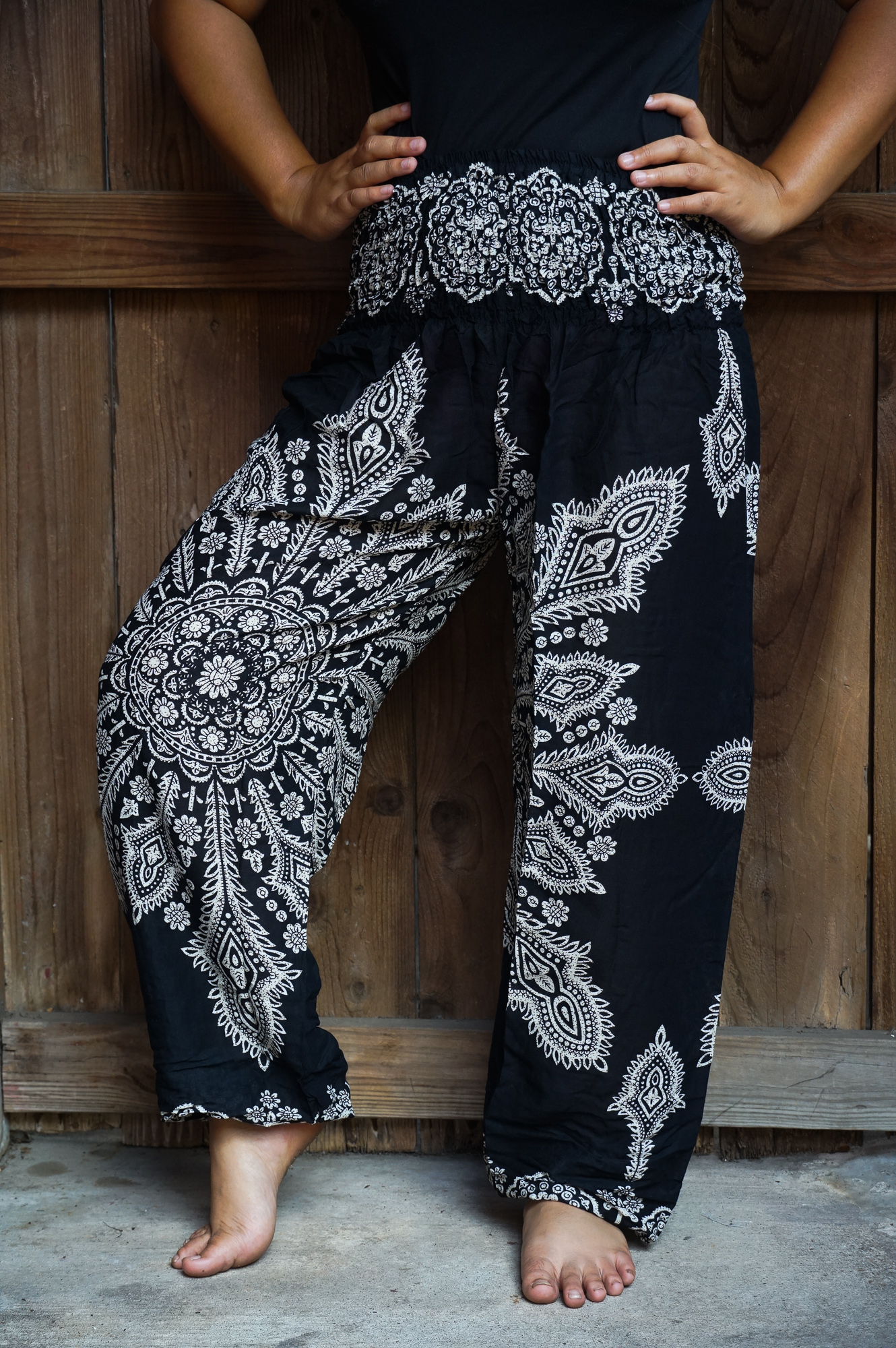 Black Butterfly Harem Pants made from 100% rayon, featuring a loose fit, elastic waist, and ankle, perfect for casual wear and yoga.