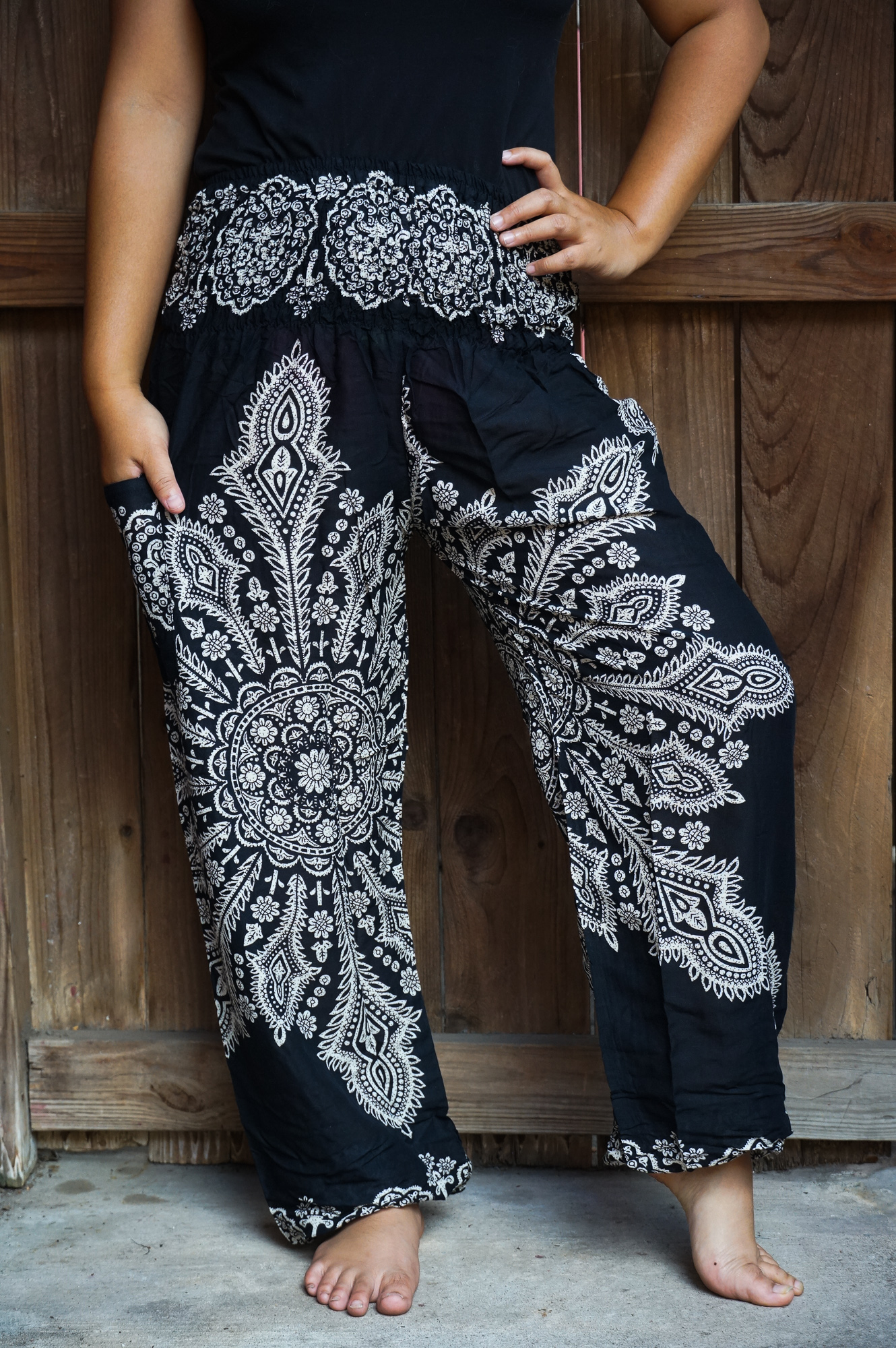 Black Butterfly Harem Pants made from 100% rayon, featuring a loose fit, elastic waist, and ankle, perfect for casual wear and yoga.