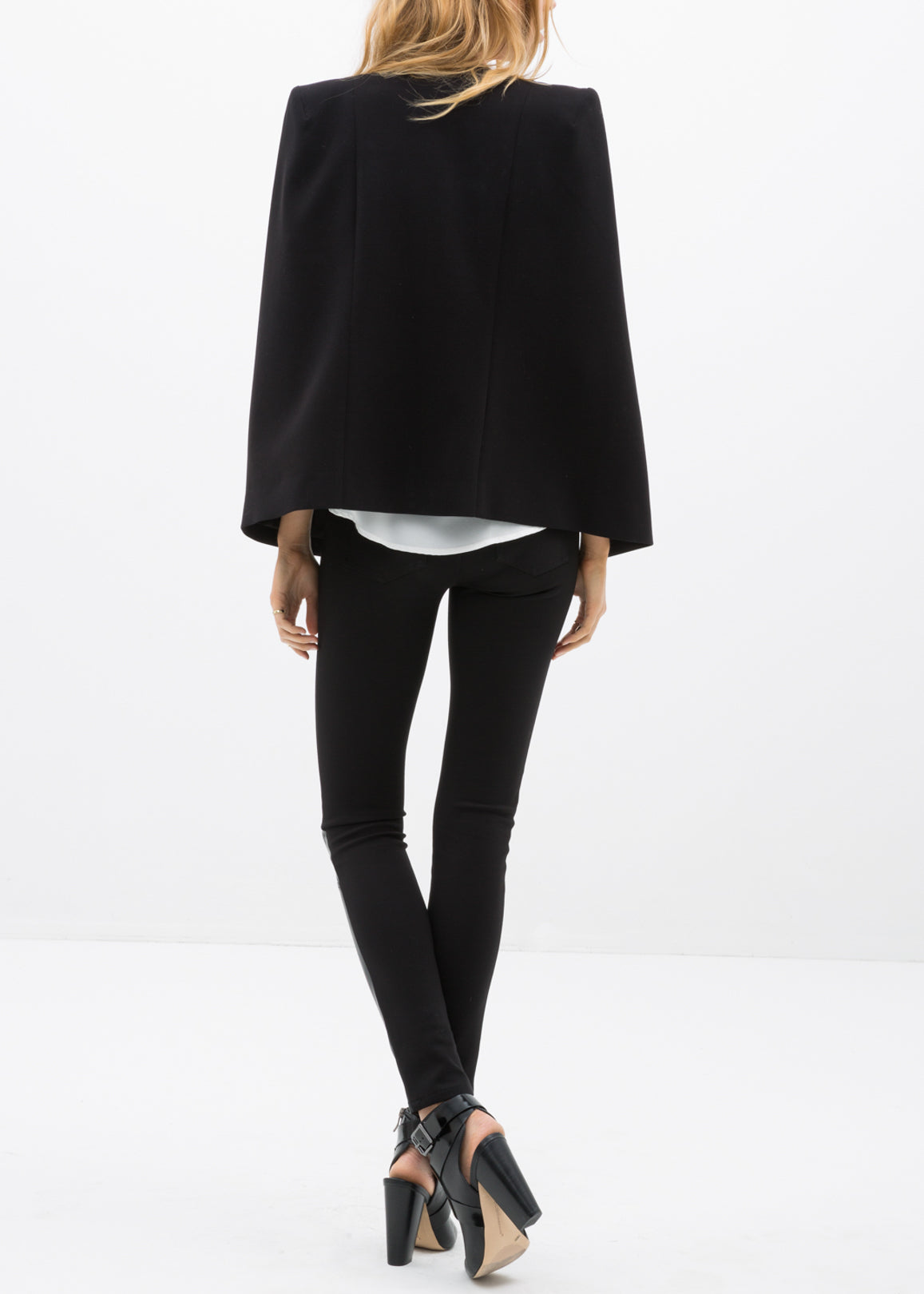 Black leather contrast skinny pants for women, showcasing a stylish mid-waist design and fitted silhouette.