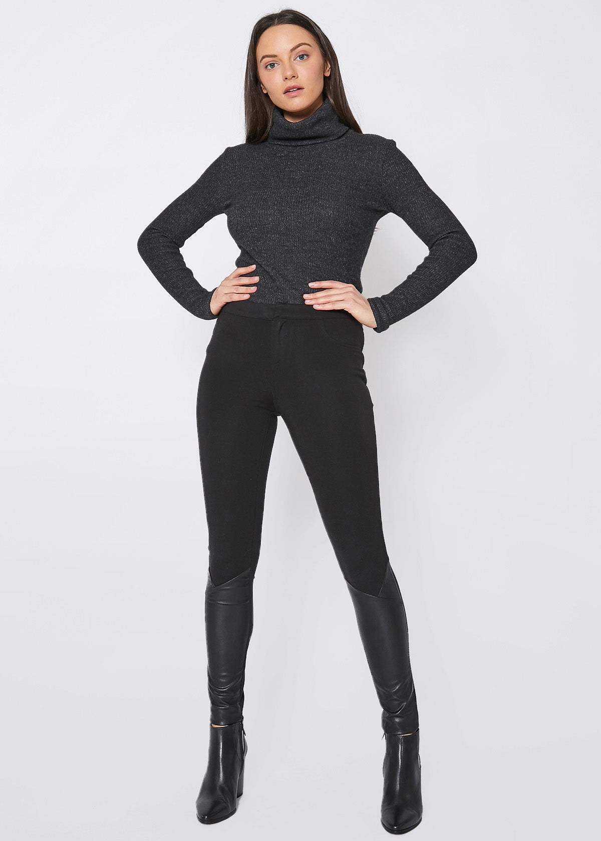 Black leather contrast skinny pants for women, showcasing a stylish mid-waist design and fitted silhouette.