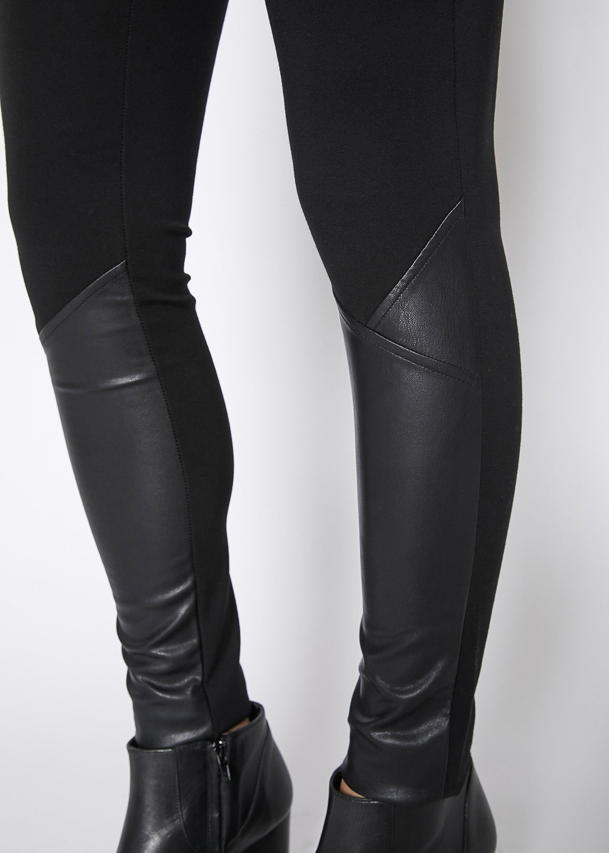 Black leather contrast skinny pants for women, showcasing a stylish mid-waist design and fitted silhouette.
