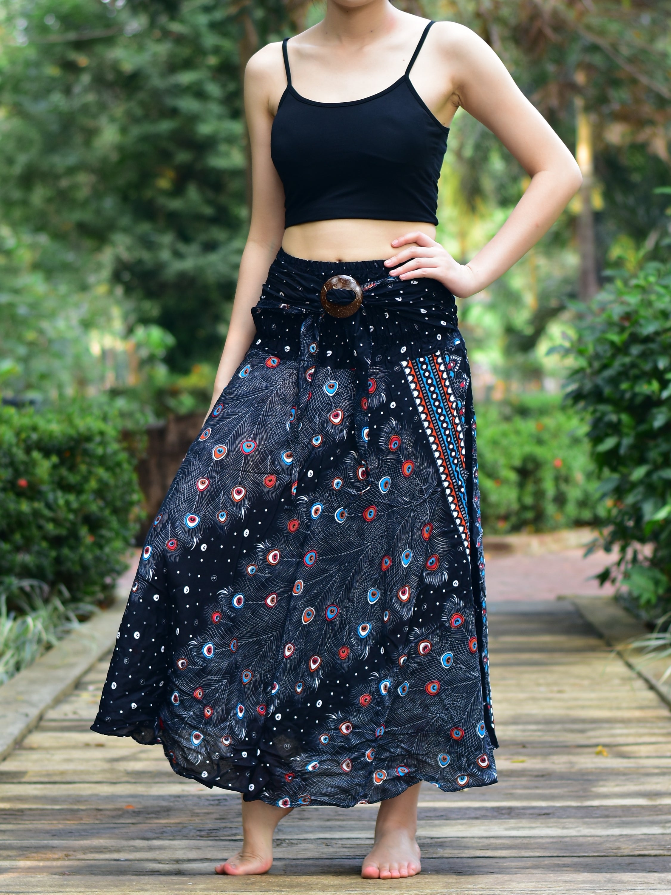 Bohotusk Black Peacock Long Skirt featuring a coconut buckle and elasticated smocked waist, styled elegantly on a model.