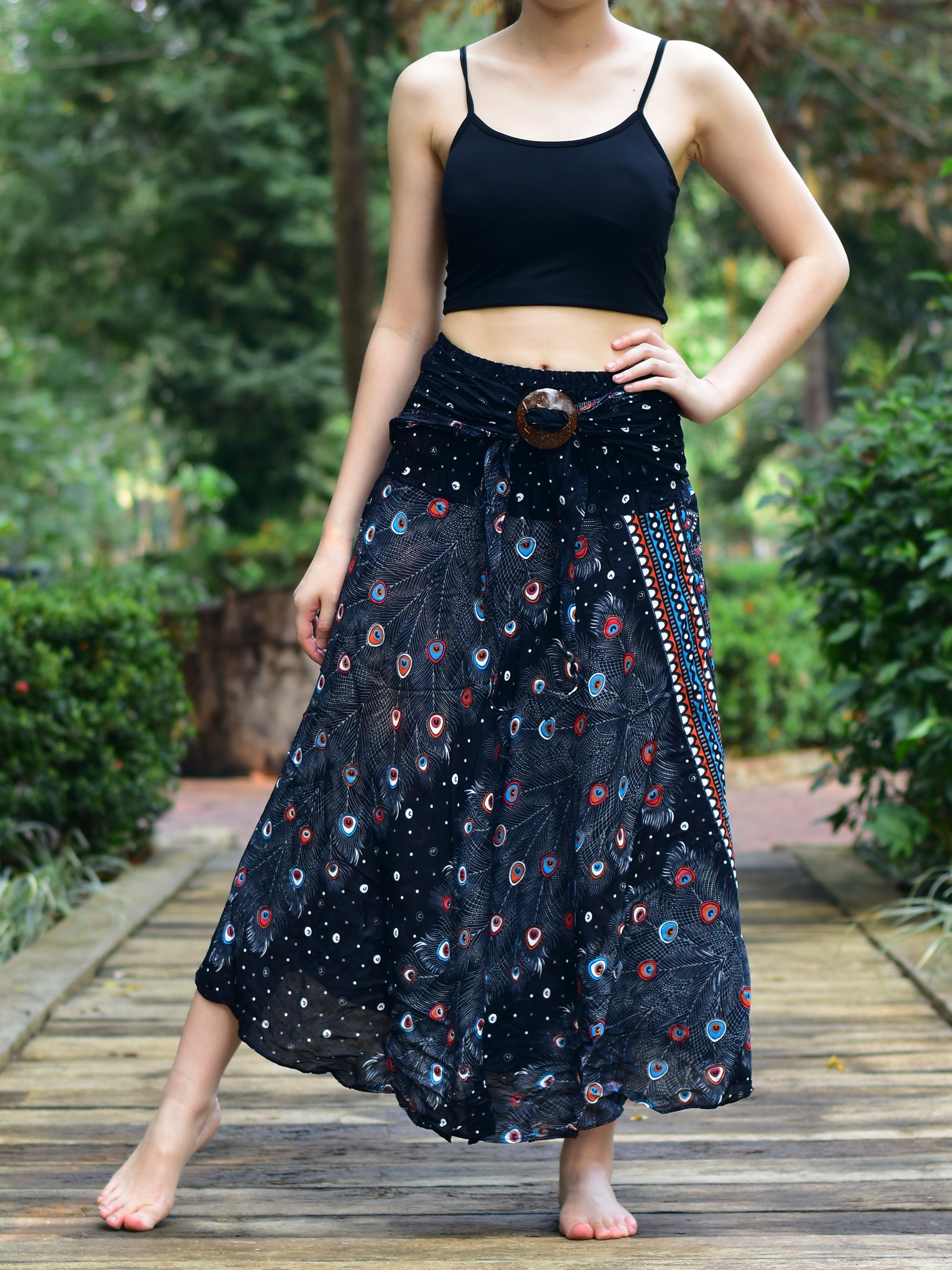Bohotusk Black Peacock Long Skirt featuring a coconut buckle and elasticated smocked waist, styled elegantly on a model.