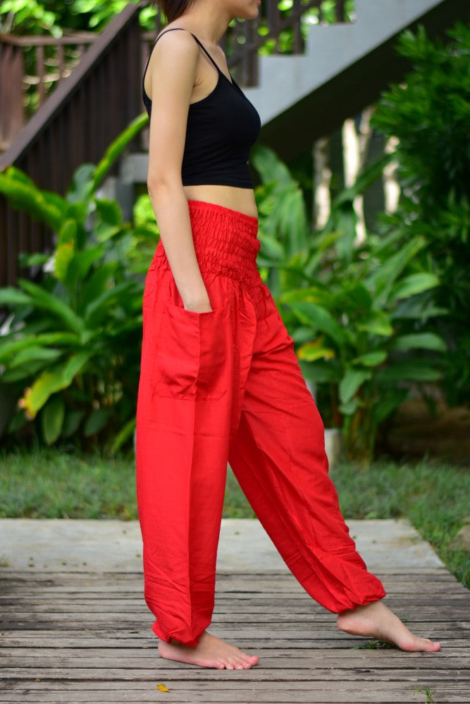 Bohotusk Orange Elephant Grassland Print trousers with elasticated smocked waist, showcasing vibrant colors and a stylish design.