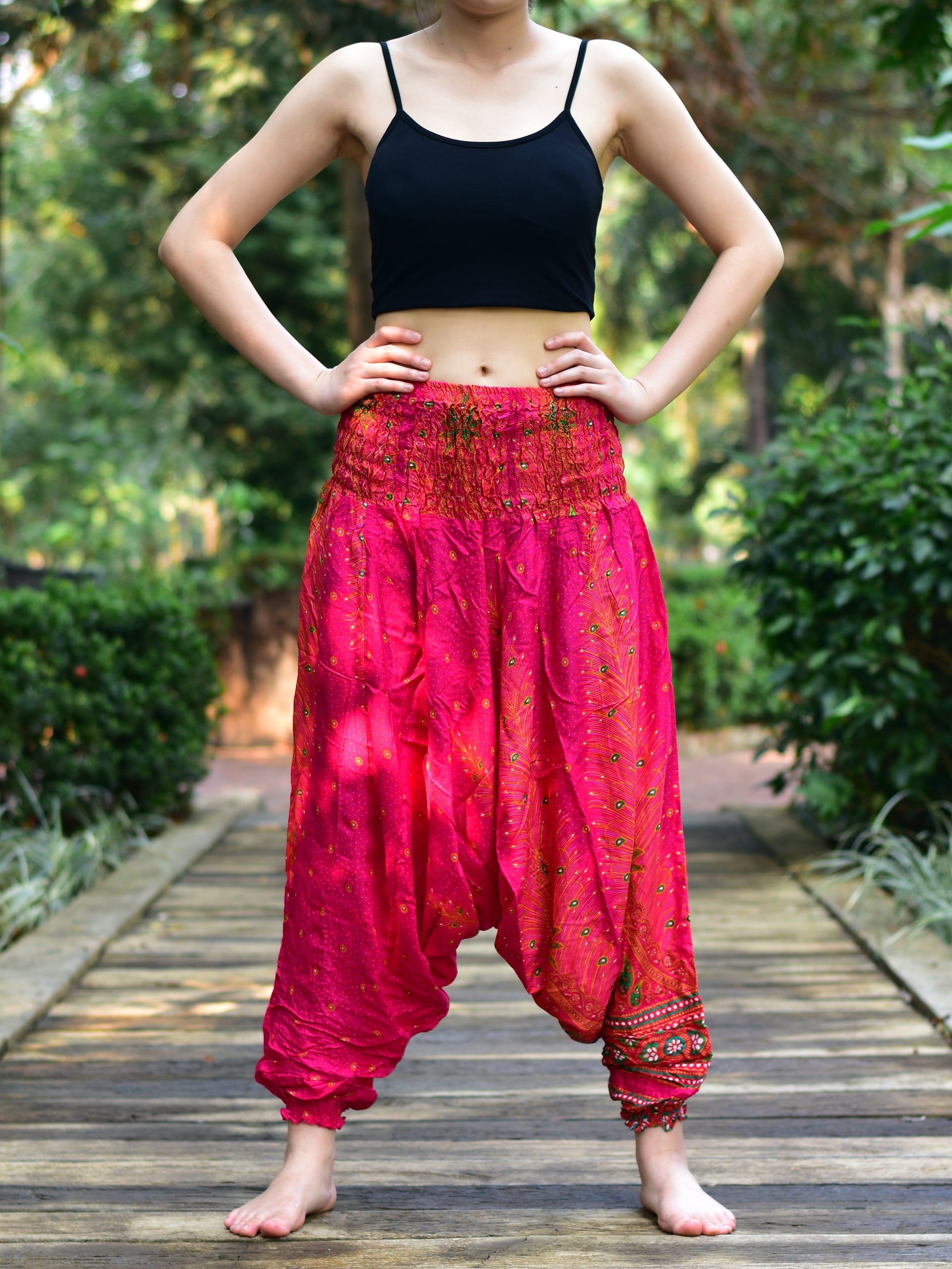 Bohotusk Pink Peacock Low Crotch Harem Pants showcasing vibrant colors and unique design, featuring a smocked waist and deep crotch for comfort.