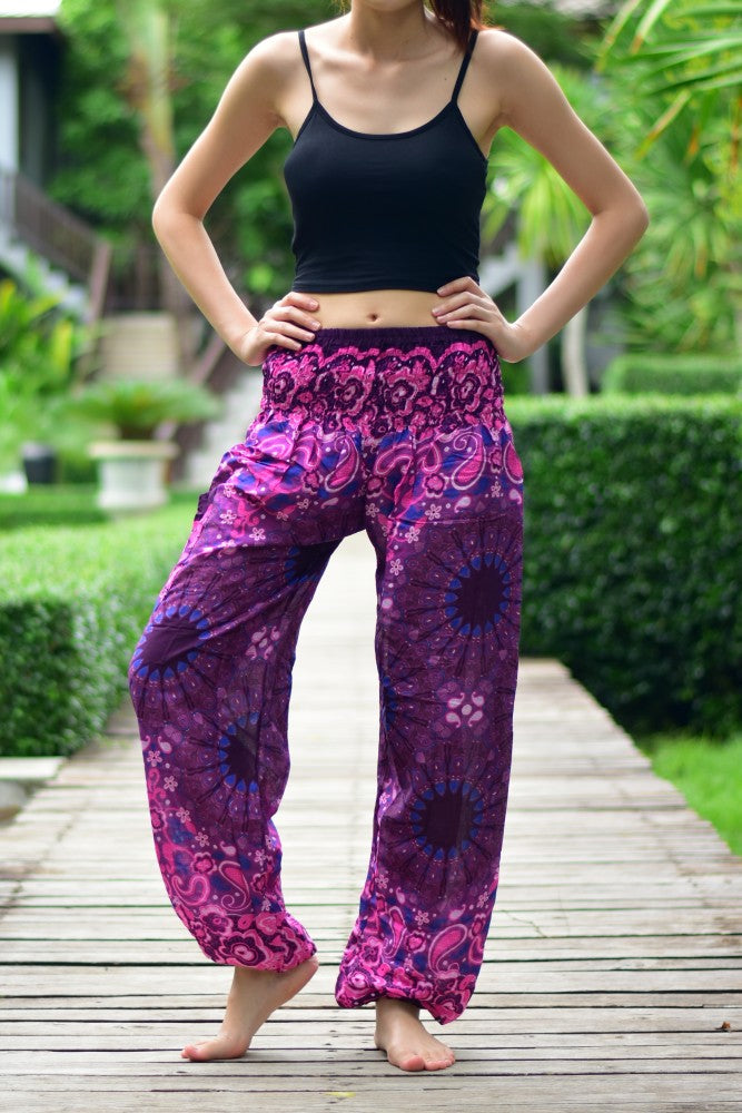 Bohotusk Purple Ink Splash Print Women's Trousers with elasticated smocked waist and ankle cuffs, showcasing vibrant colors and a stylish design.