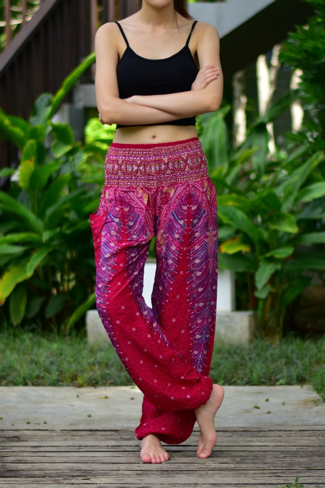Bohotusk Red Peacock Print Women's Harem Pants with elasticated waist and ankle, showcasing vibrant colors and a stylish design.