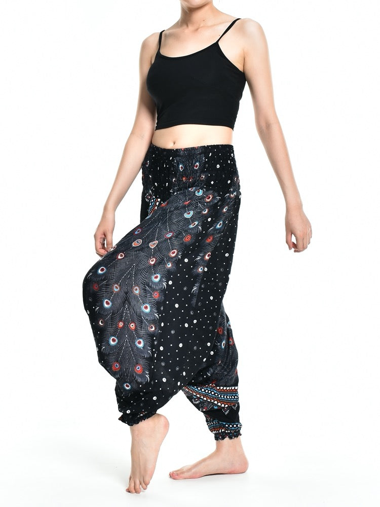 Bohotusk teal green peacock print low crotch harem pants displayed on a model, showcasing the unique design and vibrant colors.