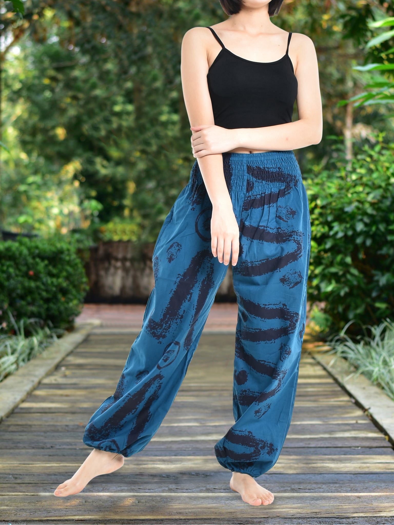 Bohotusk Women's Autumn Blue Swirl Cotton Harem Pants displayed on a model, showcasing the elasticated waist and vibrant print.