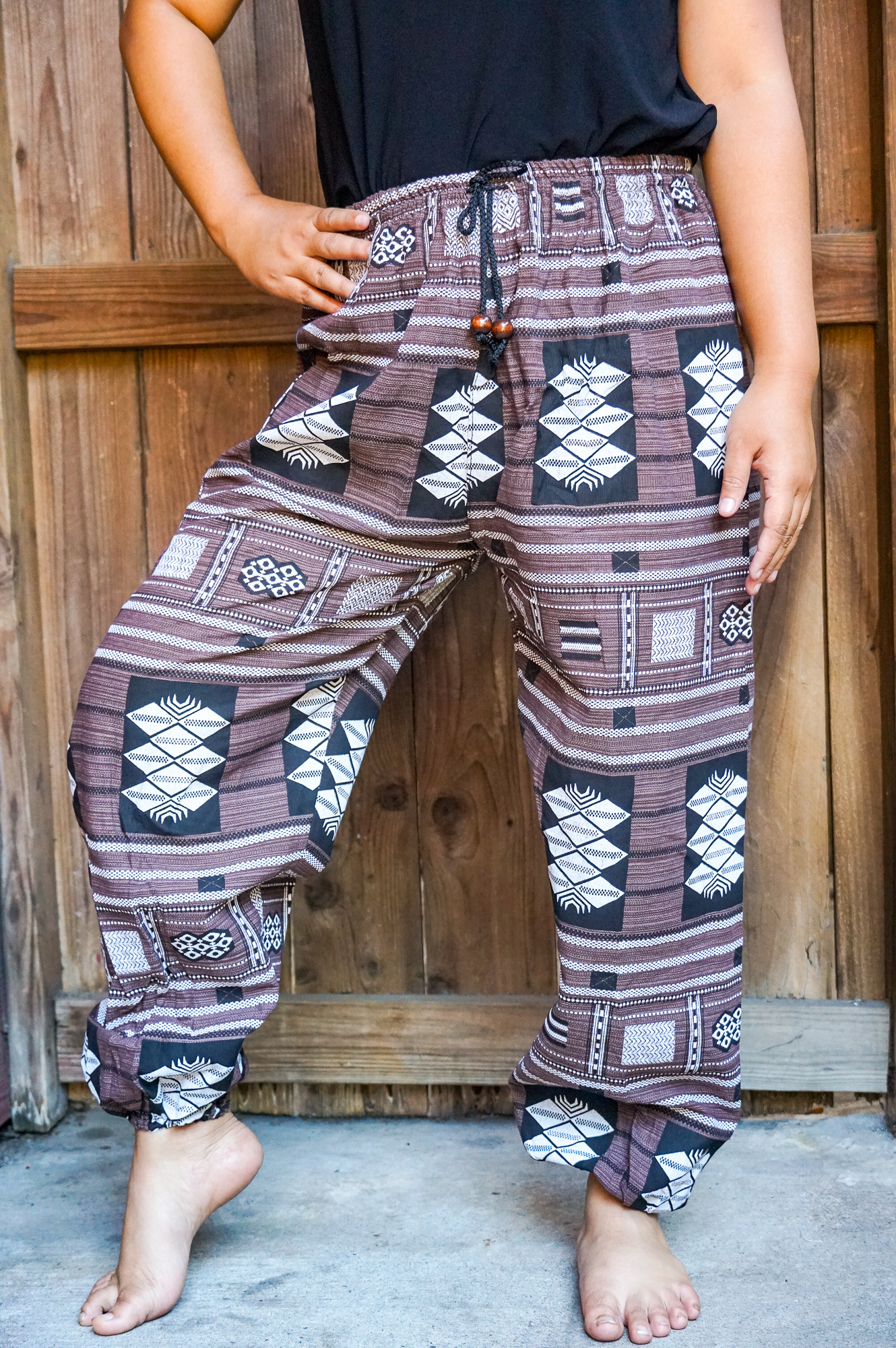 A pair of stylish Cotton Women Tribal Boho Pants featuring a soft cotton fabric, elastic drawstring waist, and boho rims, perfect for casual wear.