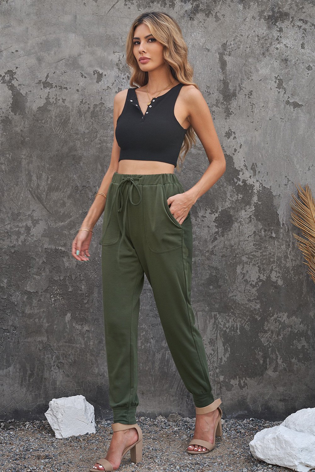 A pair of stylish green camouflage drawstring casual pants with two side pockets, perfect for everyday wear.