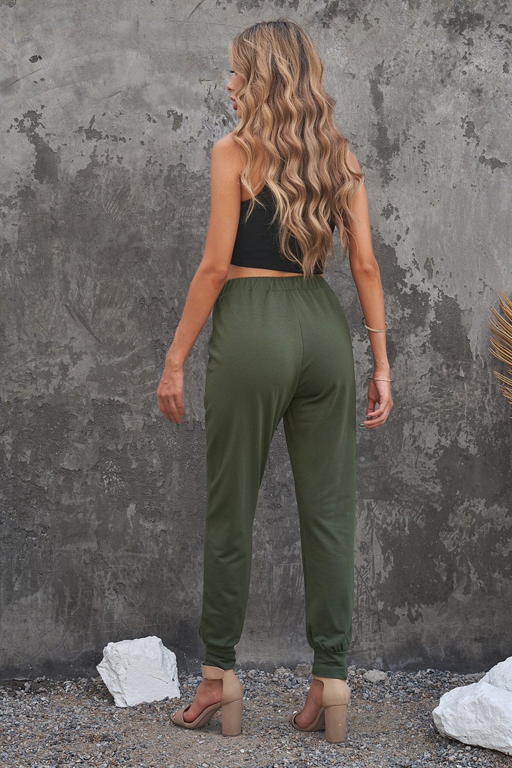A pair of stylish green camouflage drawstring casual pants with two side pockets, perfect for everyday wear.