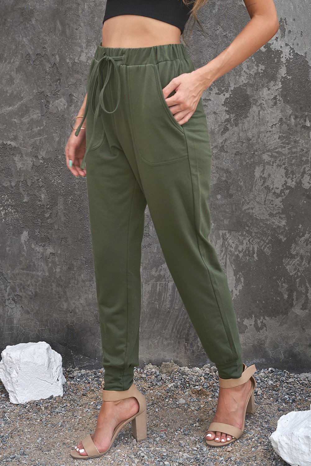 A pair of stylish green camouflage drawstring casual pants with two side pockets, perfect for everyday wear.