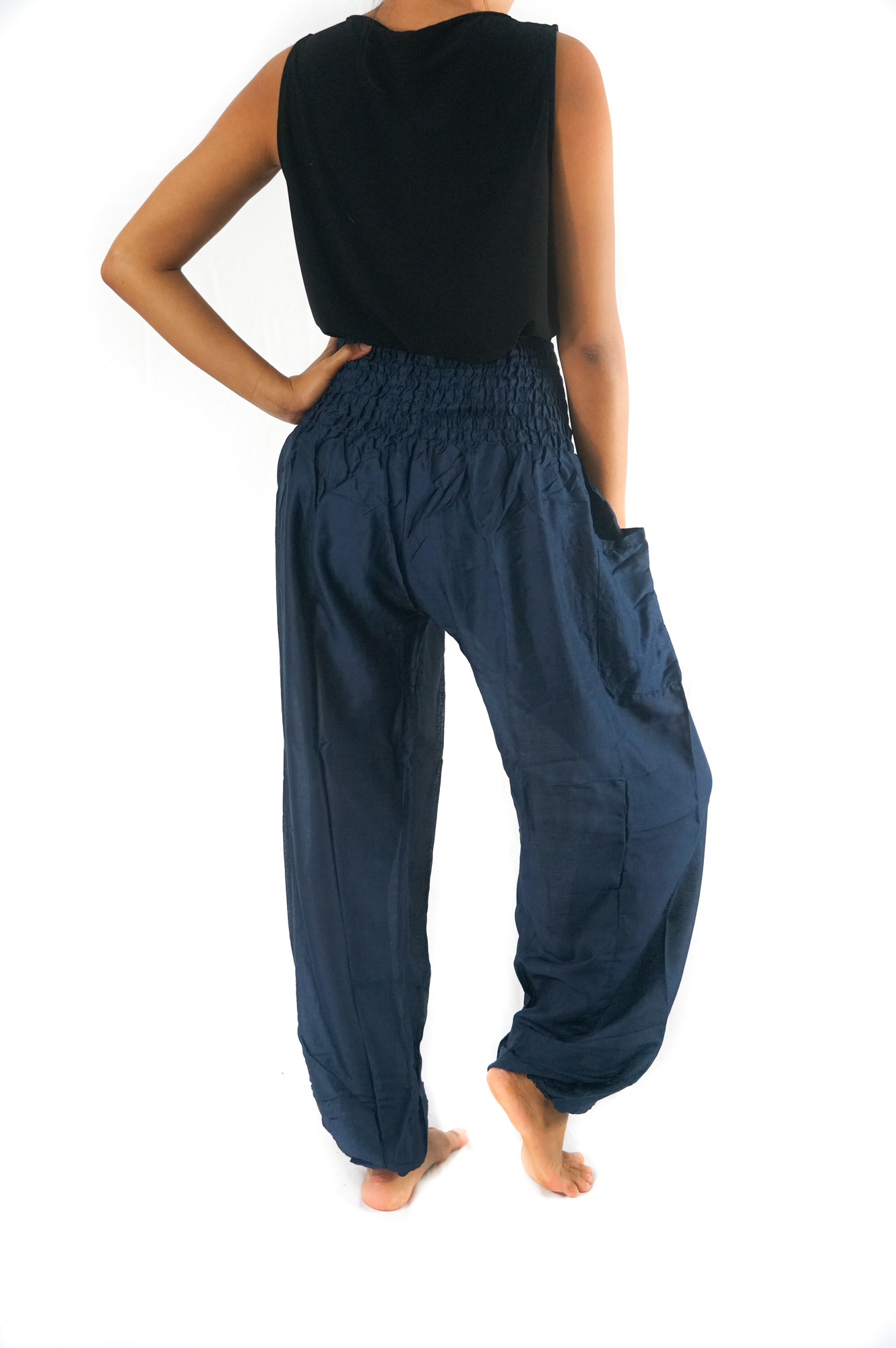 Solid blue women boho pants made of 100% rayon, featuring an elastic waist and ankle, one side pocket, and a flowy design for comfort and style.