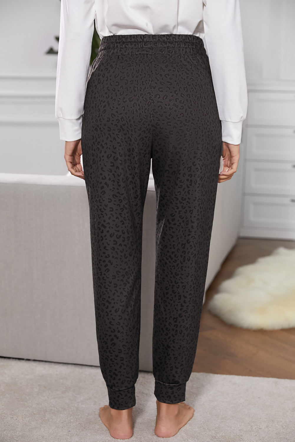 Women Casual Black Breezy Leopard Joggers featuring a stylish leopard print and adjustable smocked waist, perfect for casual wear.