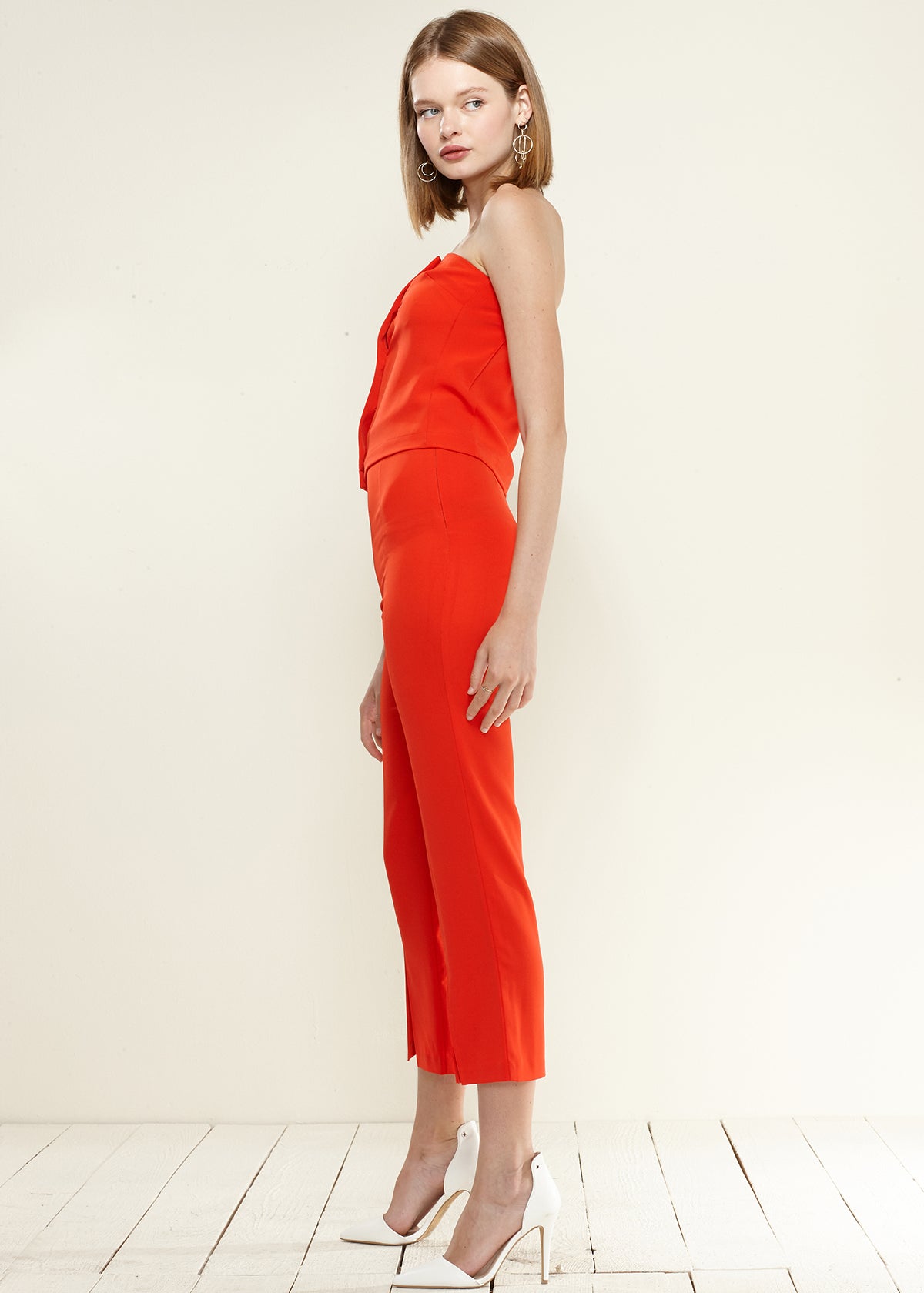 A pair of women's high-waisted cropped pants in soft poly peach twill, showcasing a stylish and comfortable design.