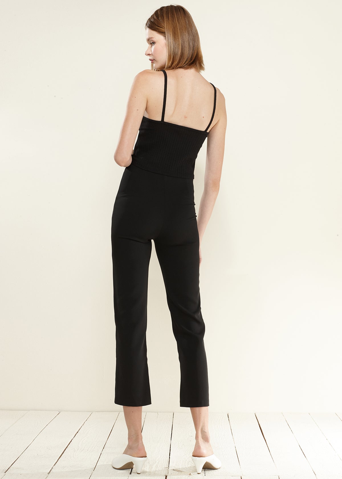 A pair of women's high-waisted cropped pants in soft poly peach twill, showcasing a stylish and comfortable design.