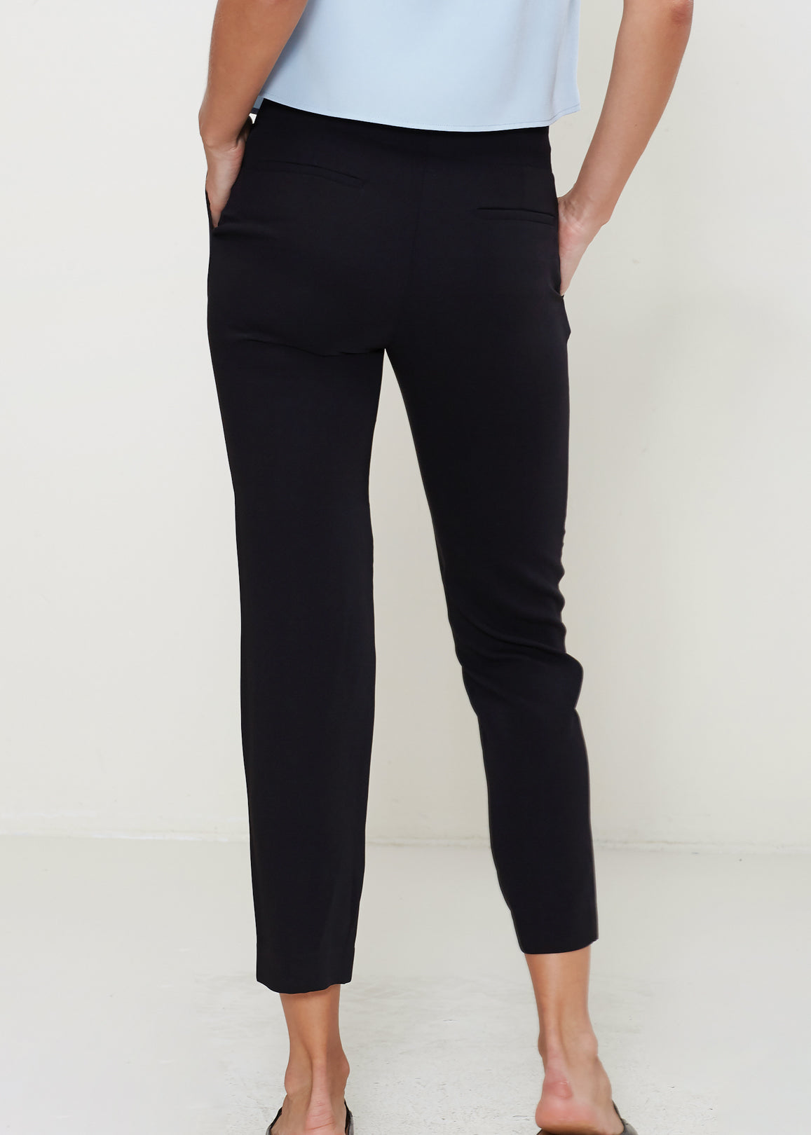 A pair of stylish women's pleat front pants made from 100% polyester, showcasing a sophisticated design suitable for various occasions.