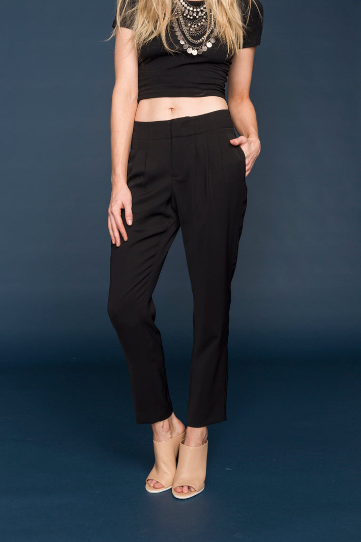 A pair of stylish women's pleat front pants made from 100% polyester, showcasing a sophisticated design suitable for various occasions.