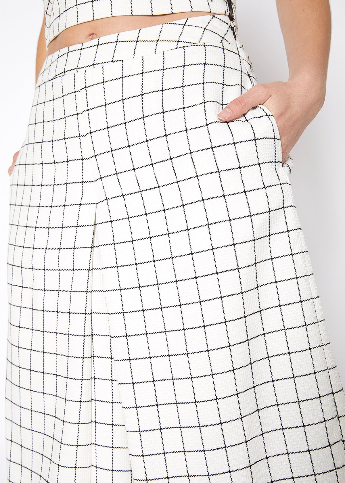 A pair of women's wide leg pants in square jacquard pattern, featuring pleated inseam and hidden side pockets.