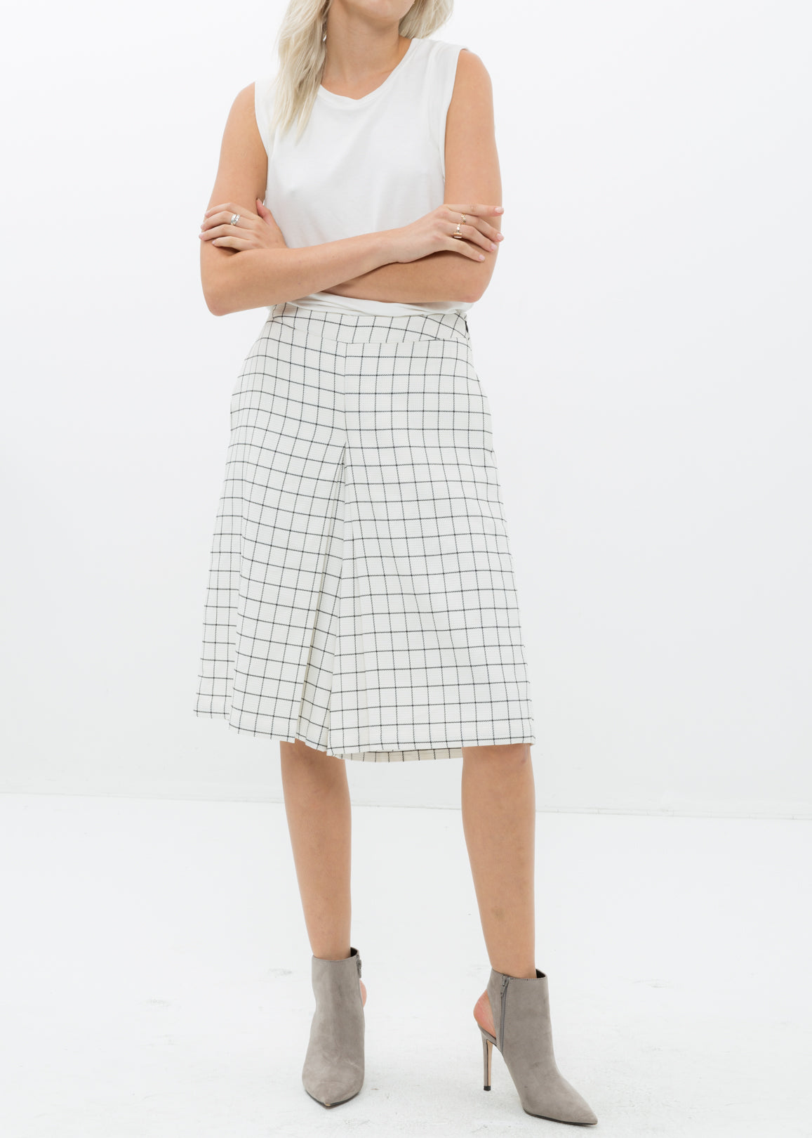 A pair of women's wide leg pants in square jacquard pattern, featuring pleated inseam and hidden side pockets.