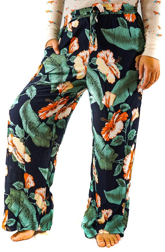 A pair of XS-M Leaf Print Pants for women, featuring a vibrant leaf pattern, drawstring waist, and two side pockets, made from lightweight rayon fabric.