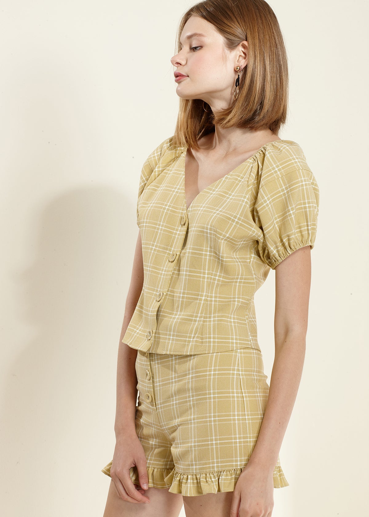 Women's plaid ruffle hem high waist shorts in a stylish design, showcasing the trendy pattern and ruffle detail.