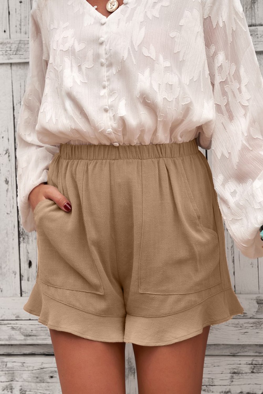 A pair of women's khaki shorts featuring ruffled details and side pockets, made from breathable linen cotton blend, perfect for summer wear.