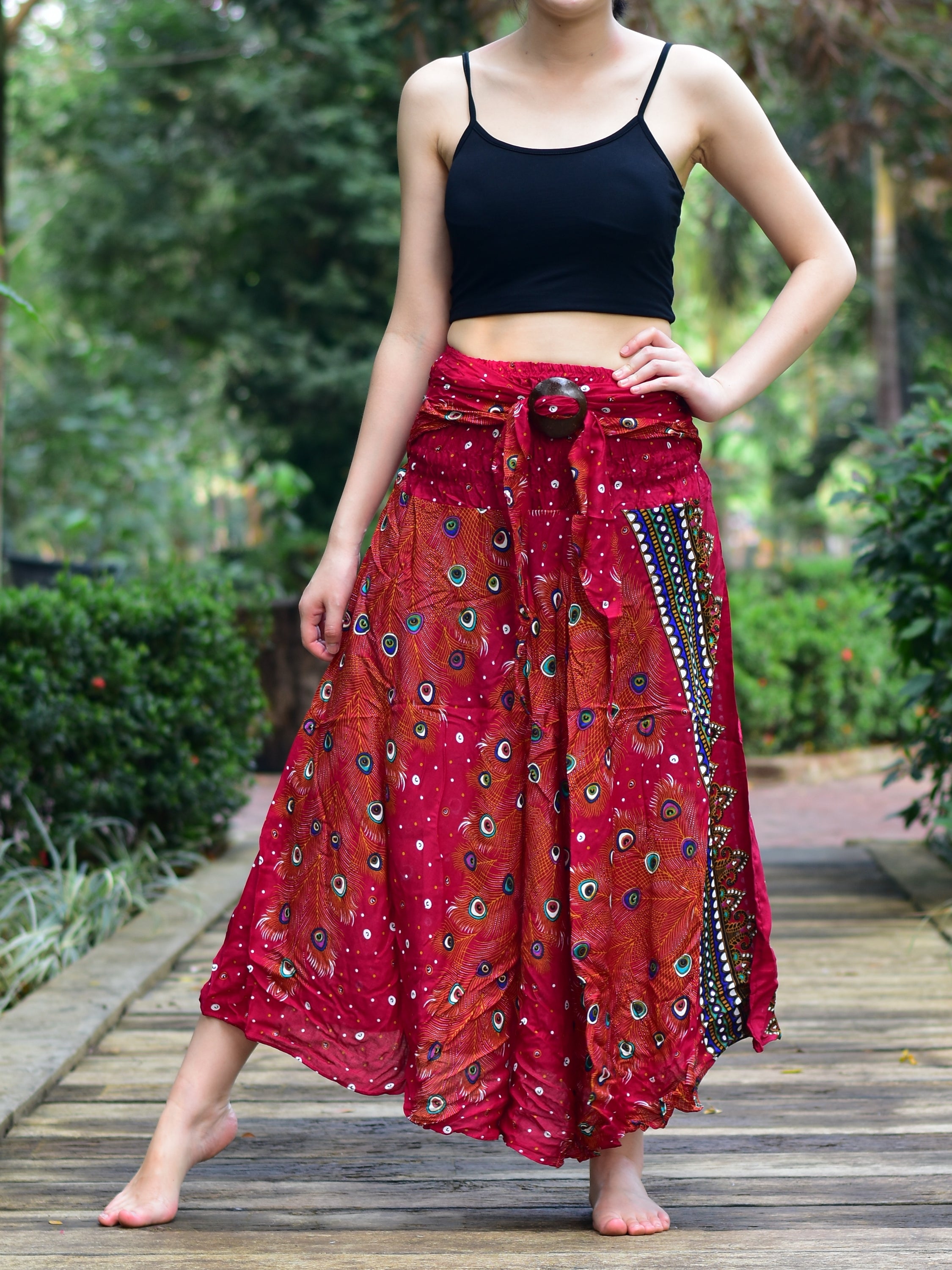 Bohotusk Burnt Red Peacock Long Skirt featuring a coconut buckle and smocked waist, styled elegantly on a mannequin.