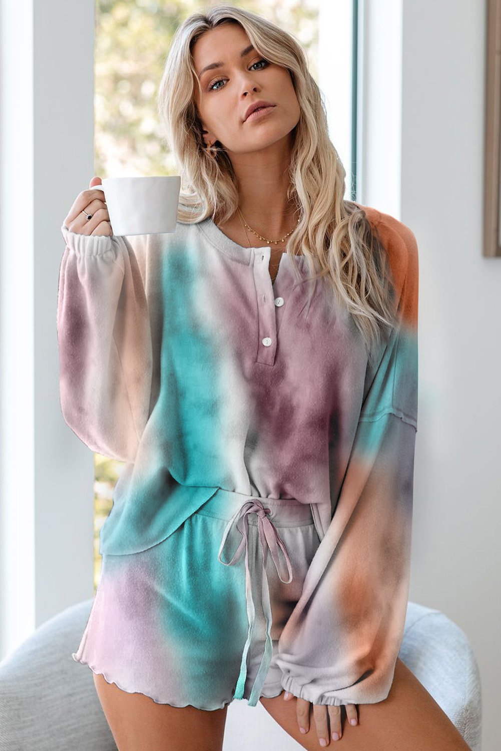 Multicolor Tie Dye Knit Long Sleeve Pajamas Set featuring a long sleeve pullover top with button closure and elastic drawstring waist shorts with ruffle hemline.