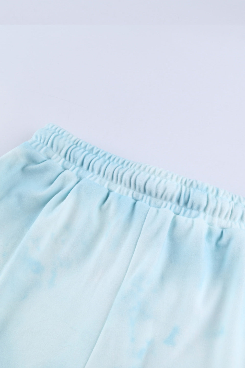 Sky Blue Tie Dye Knit Pajamas Set featuring a long sleeve top and shorts with a chic tie dye pattern and ruffle hemline.