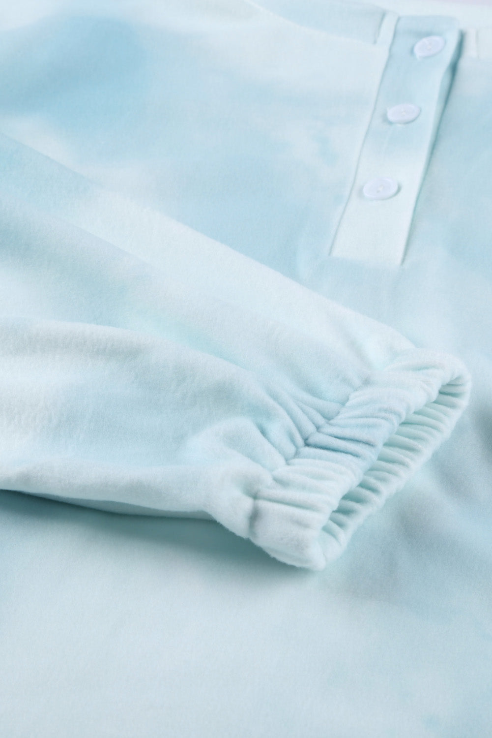 Sky Blue Tie Dye Knit Pajamas Set featuring a long sleeve top and shorts with a chic tie dye pattern and ruffle hemline.