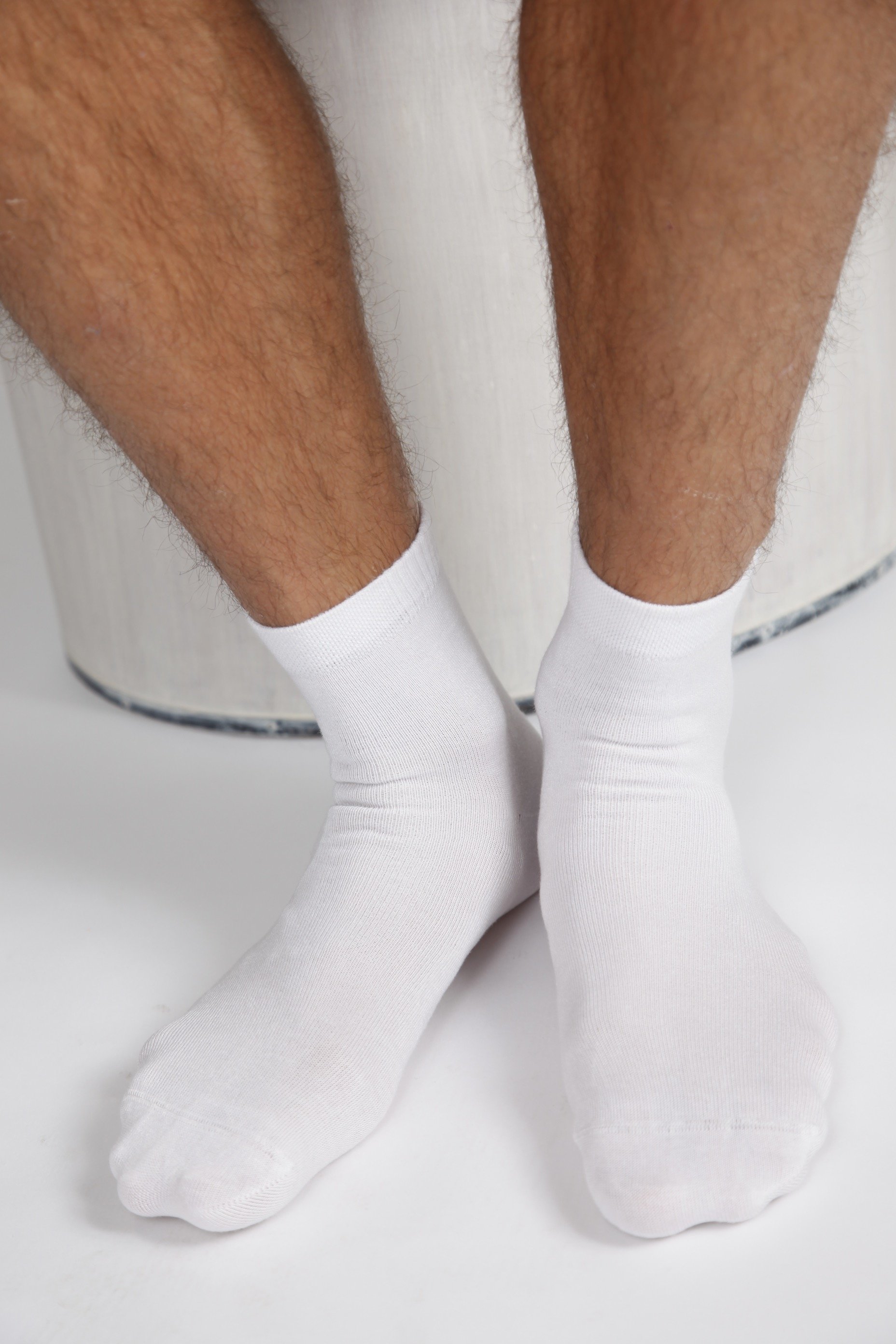 A pair of ALEX white bamboo viscose socks for men, showcasing their soft texture and low-cut design.