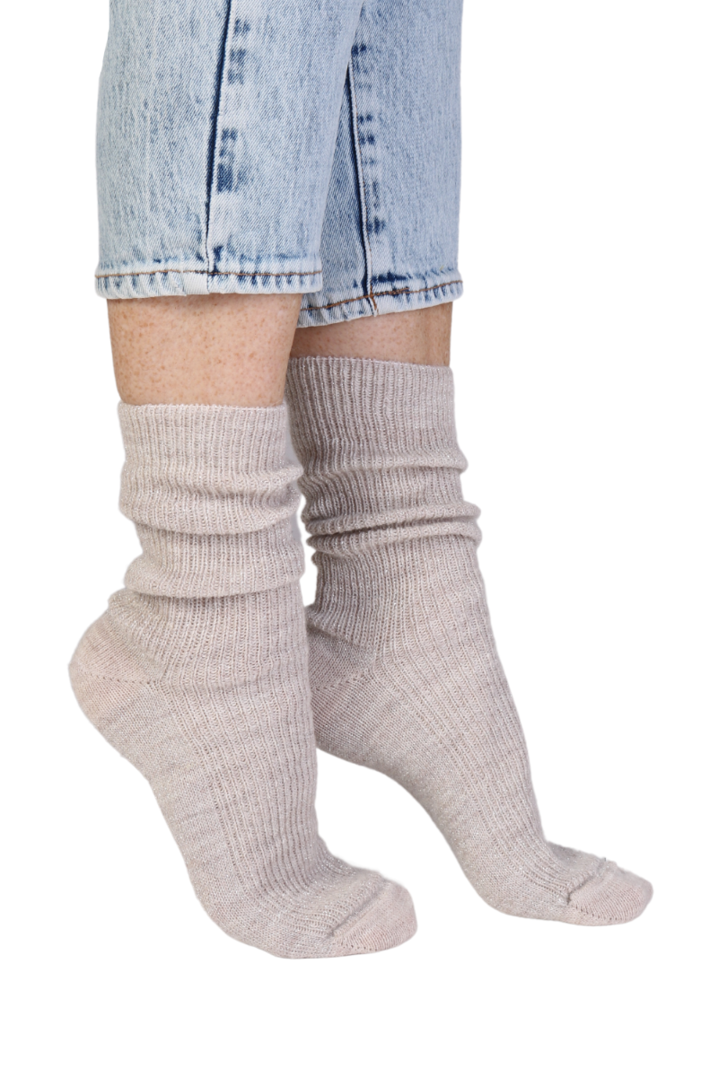 Light beige sparkly socks made from alpaca wool, showcasing a soft texture and elegant design.