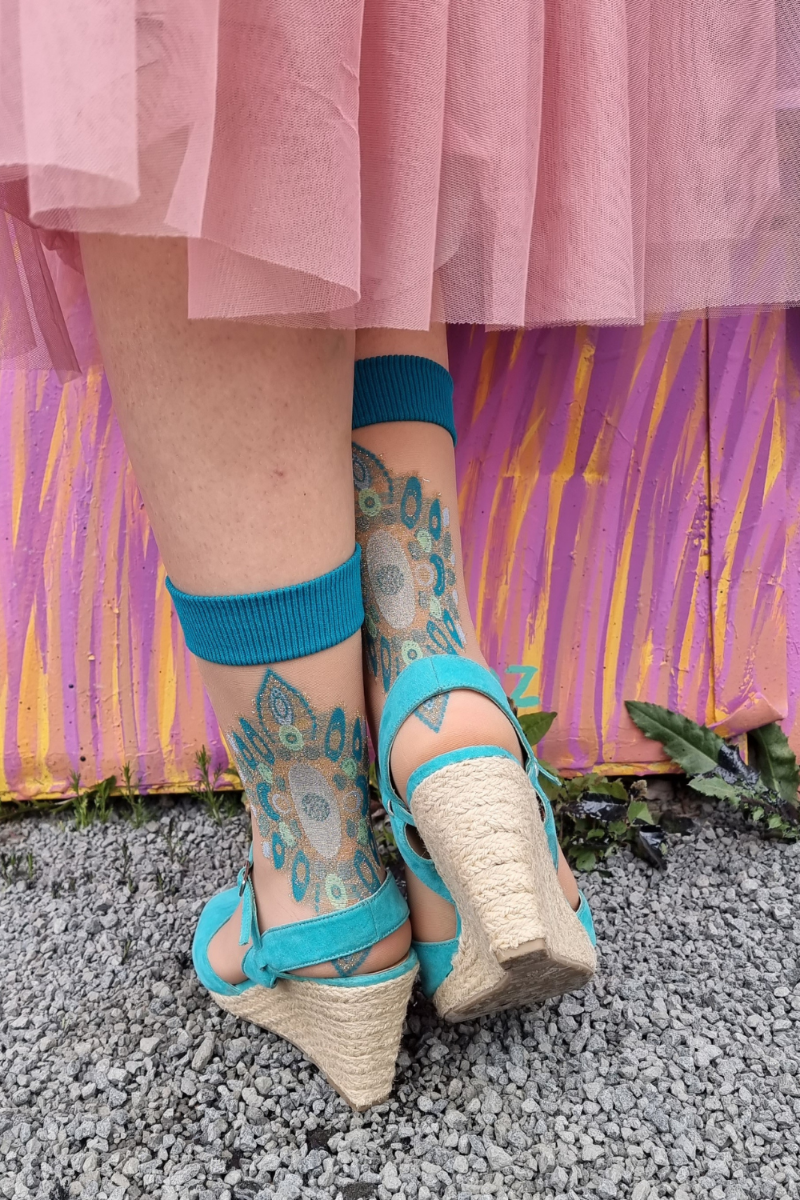 DALILA beige sheer socks featuring a glittering green pattern on the heel, perfect for stylish footwear.