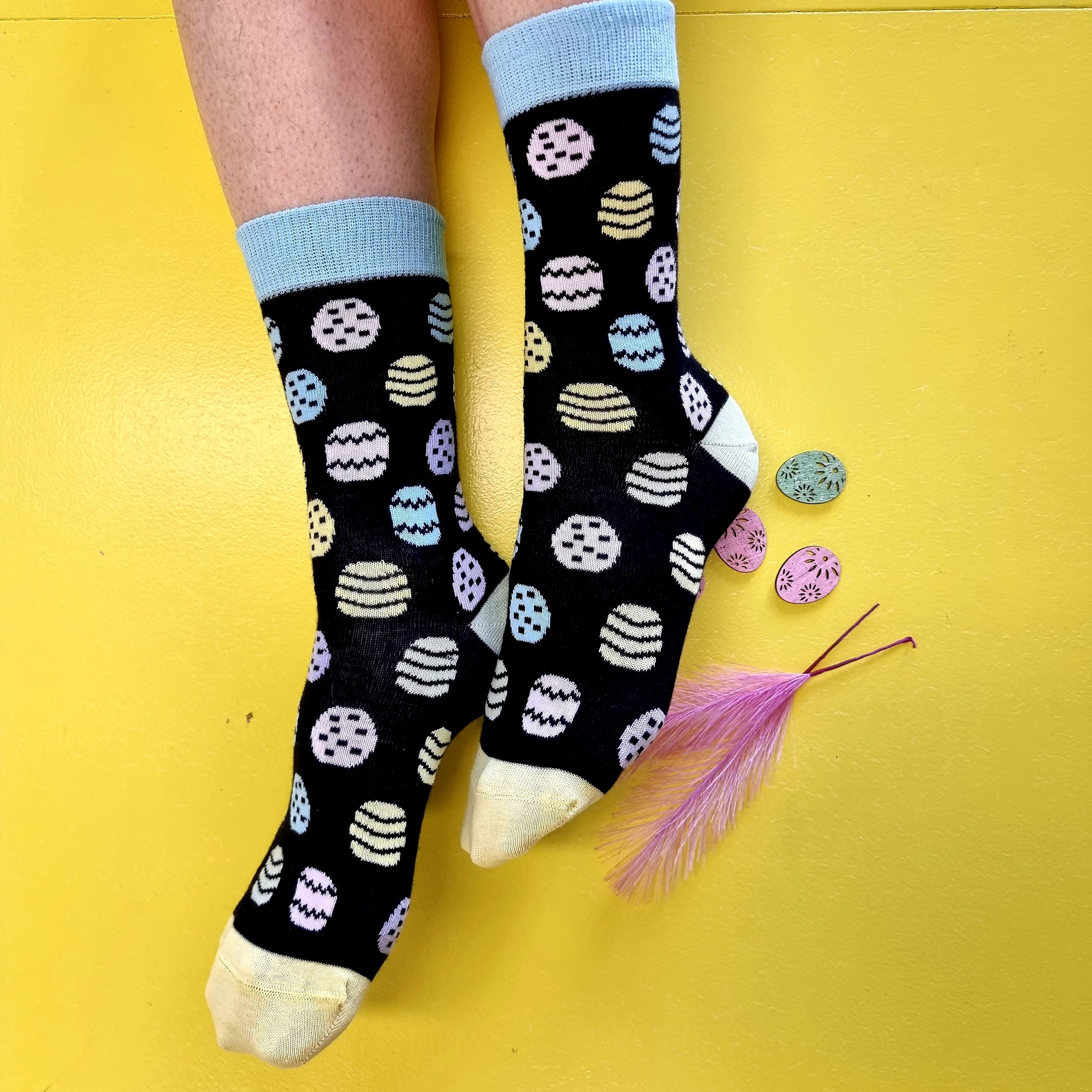 EGGNUTS cotton Easter socks featuring a blue color with bunny designs and colorful egg patterns, perfect for Easter celebrations.