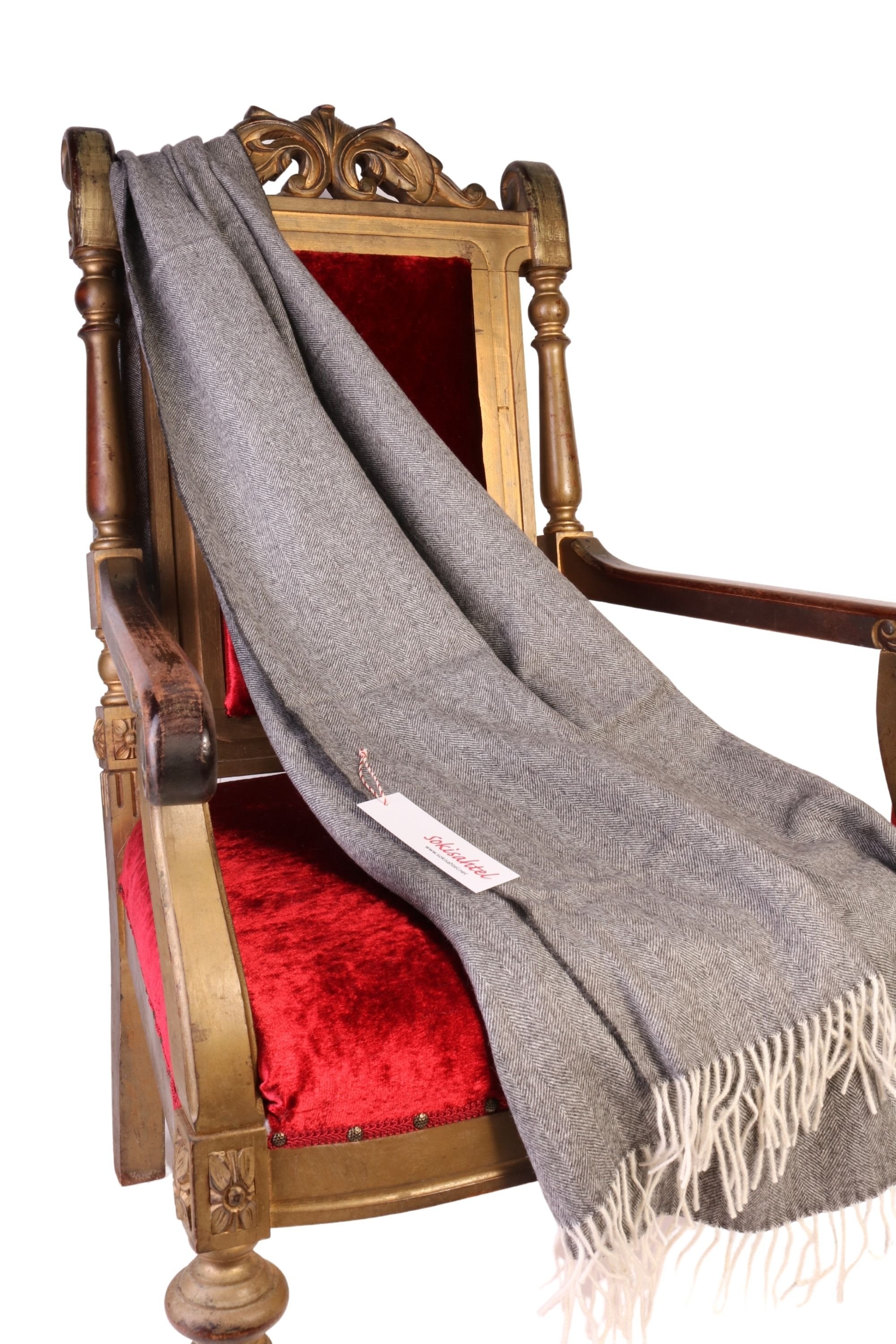 Luxurious grey herringbone patterned alpaca wool plaid, showcasing its soft texture and elegant design, perfect for winter warmth.