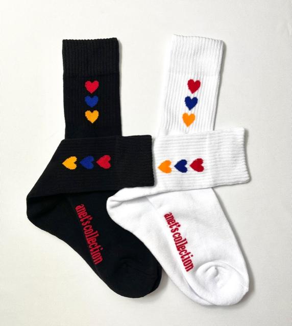 Hearts of Armenia Socks featuring jacquard design with red, orange, and blue hearts on a black and white background.